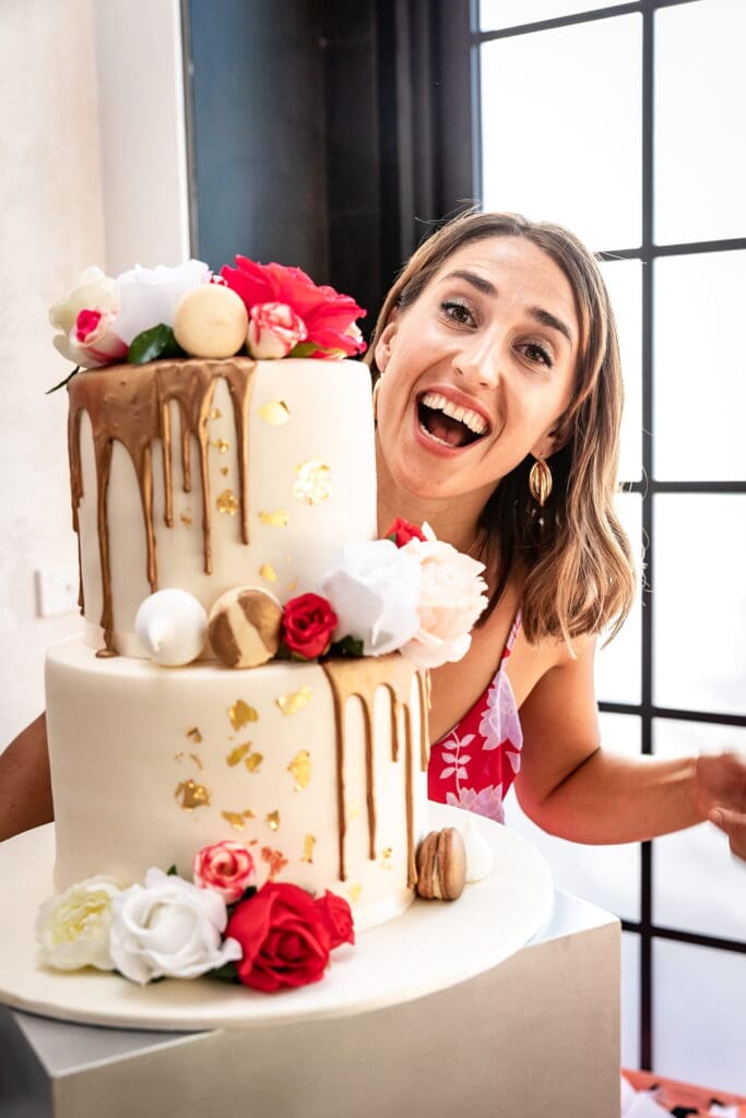 A joyful woman smiles, reflecting the charm of personalized cake toppers for a memorable and unique wedding experience.