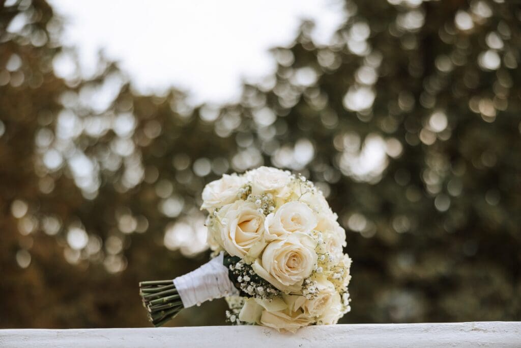 Elegant wedding bouquet of white roses and baby's breath, perfect for advice on seasonal wedding booking and high-demand wedding venues.