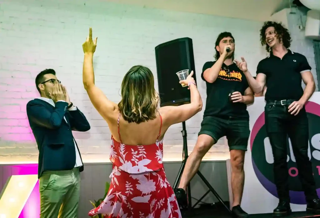 Woman dancing with enthusiasm during a karaoke session at a party.