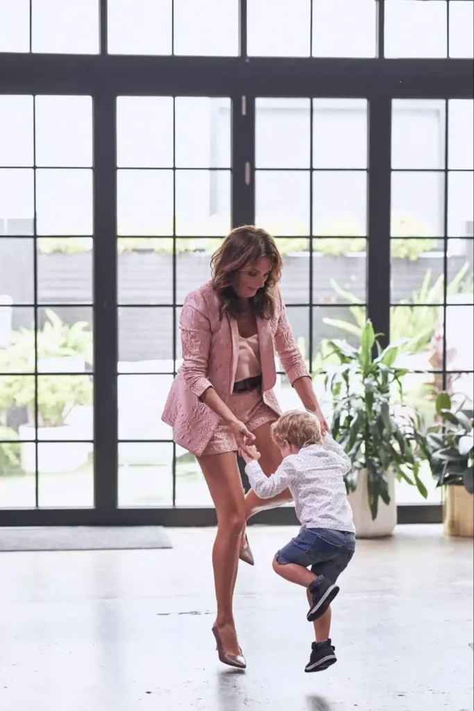 Nash, founder of Canvas House, playing and dancing with a child in a bright indoor space.