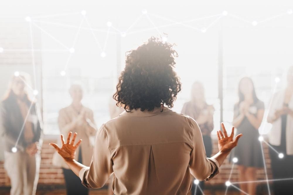 In a Melbourne seminar venue, a person addresses a group of attendees, sharing insights and information.