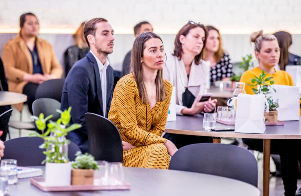 Guests listening to panel speaker at a corporate event